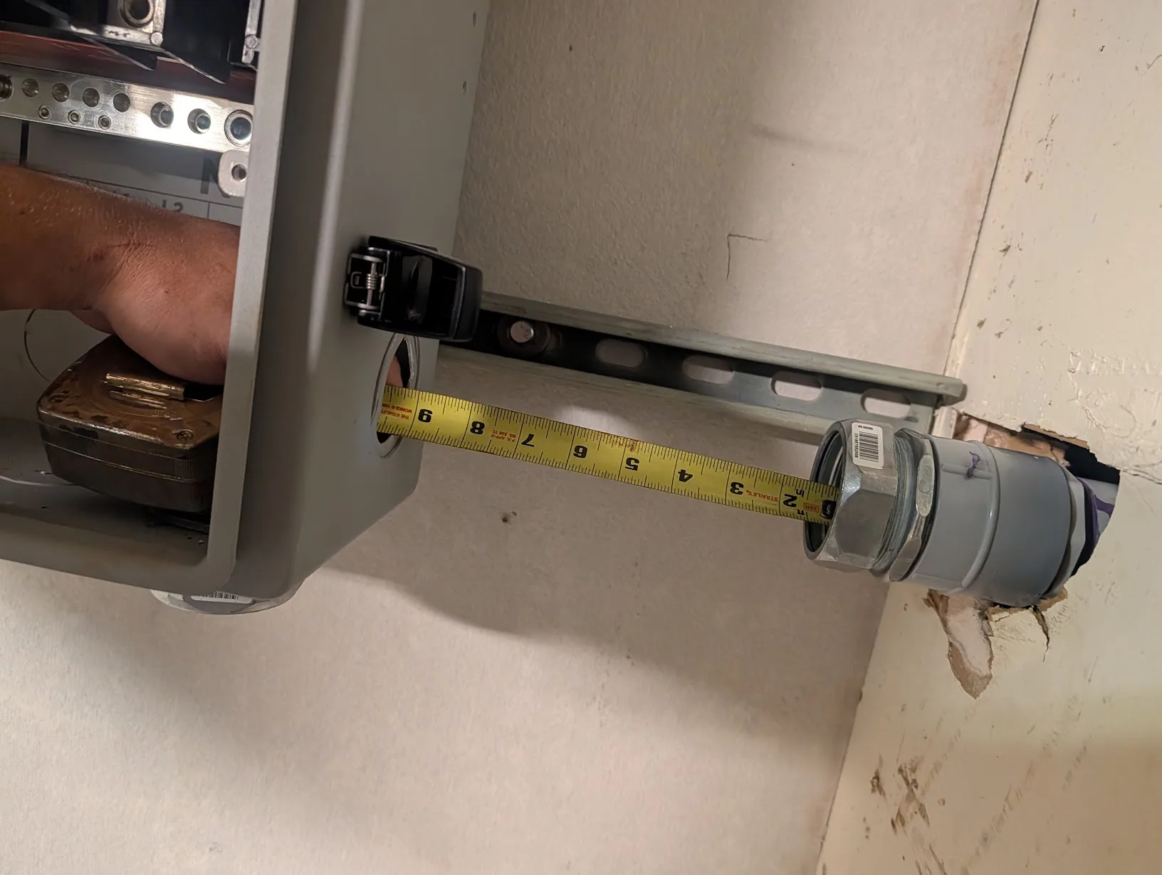 Measuring the 2\" EMT stub between the GridBoss and the exterior wall fitting