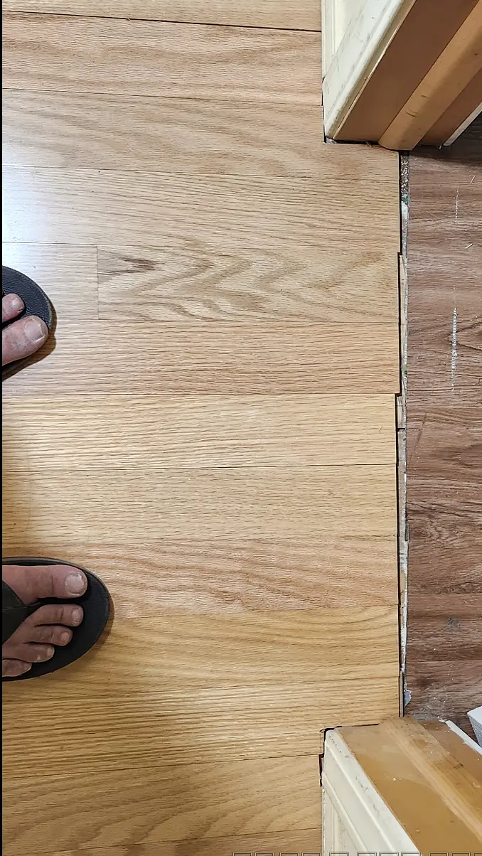 Picture showing jagged edge of new wood flooring