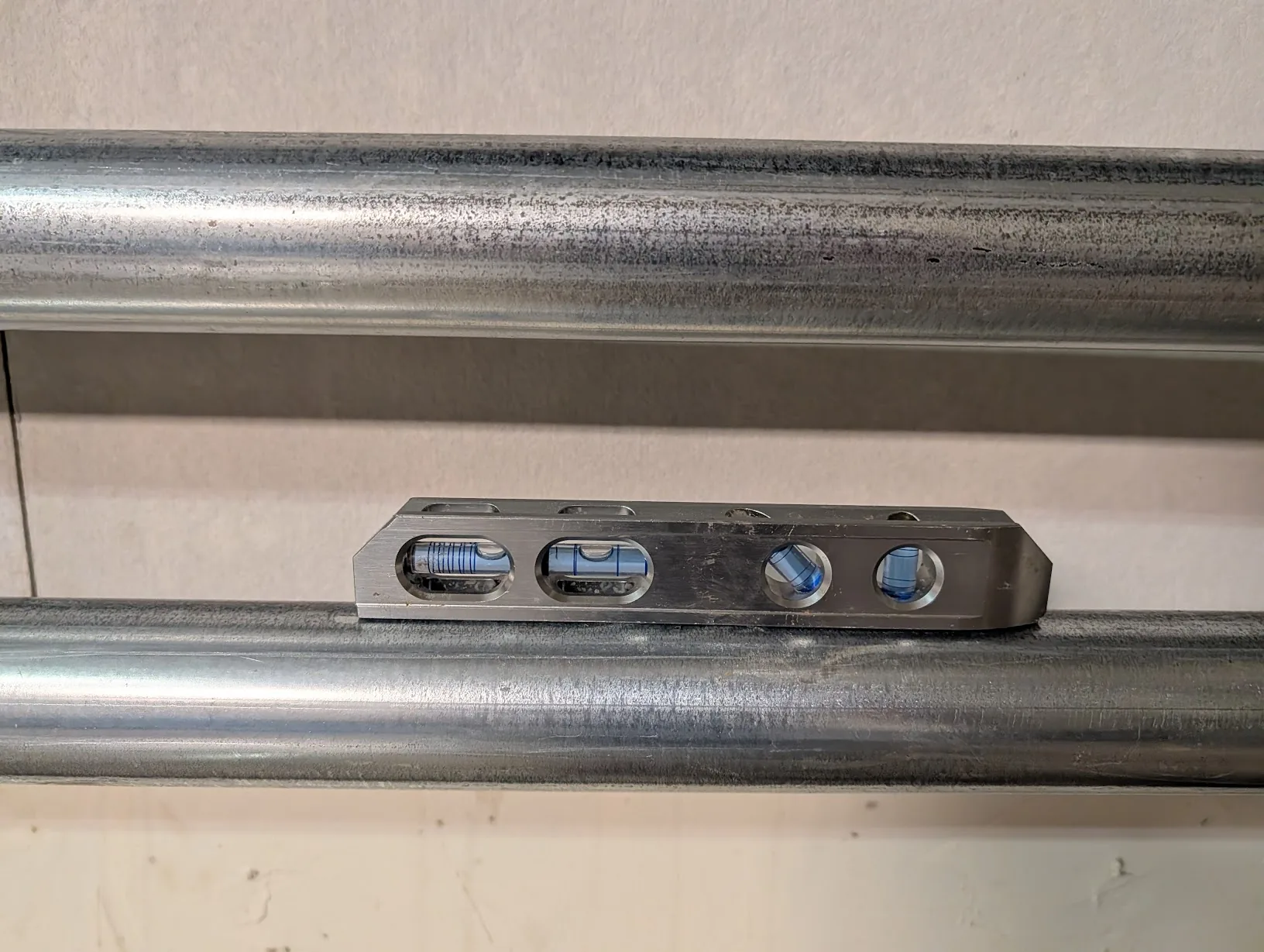 Torpedo level across both runs of EMT confirming both are level and parallel