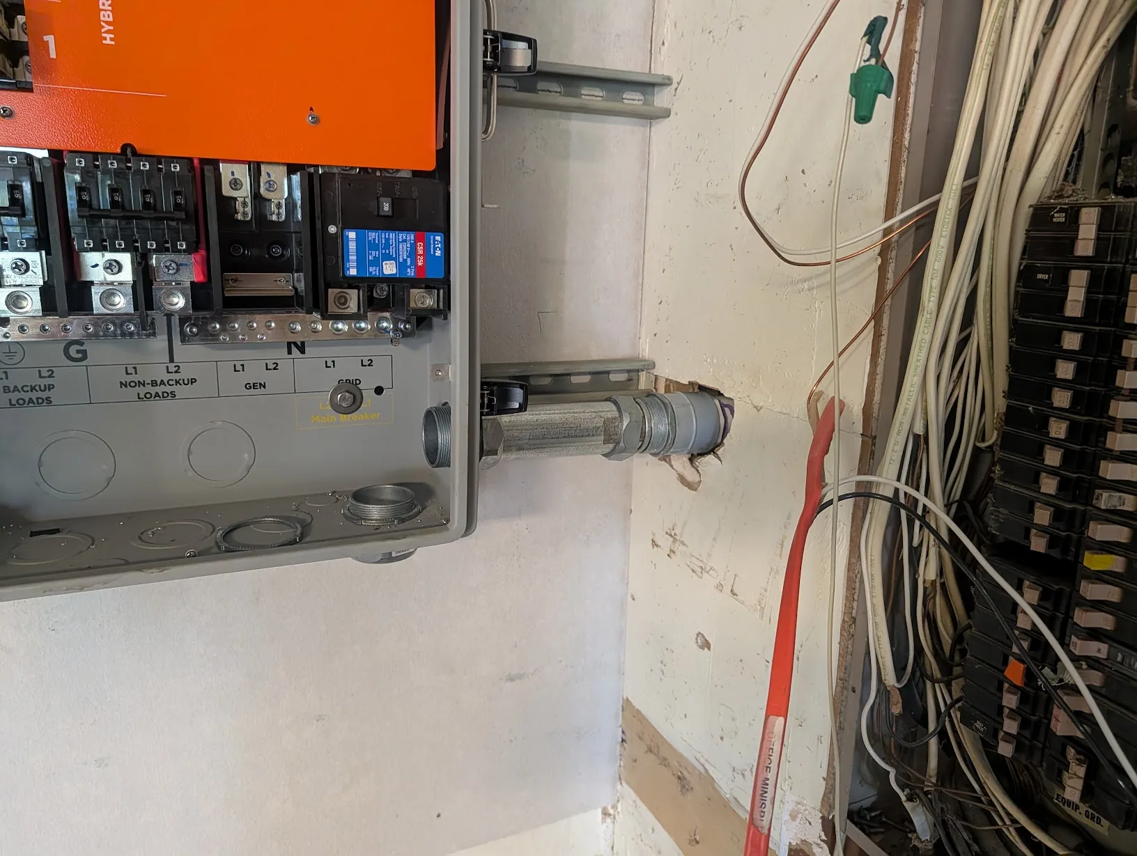 Cut and threaded 2" EMT test-fit between the GridBoss and the wall hub