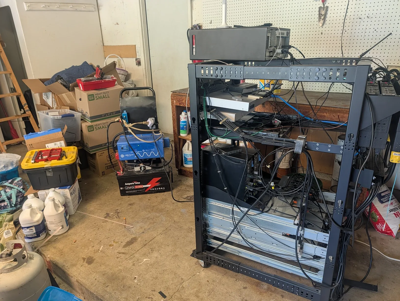 Server rack mid-move with the portable UPS underneath it