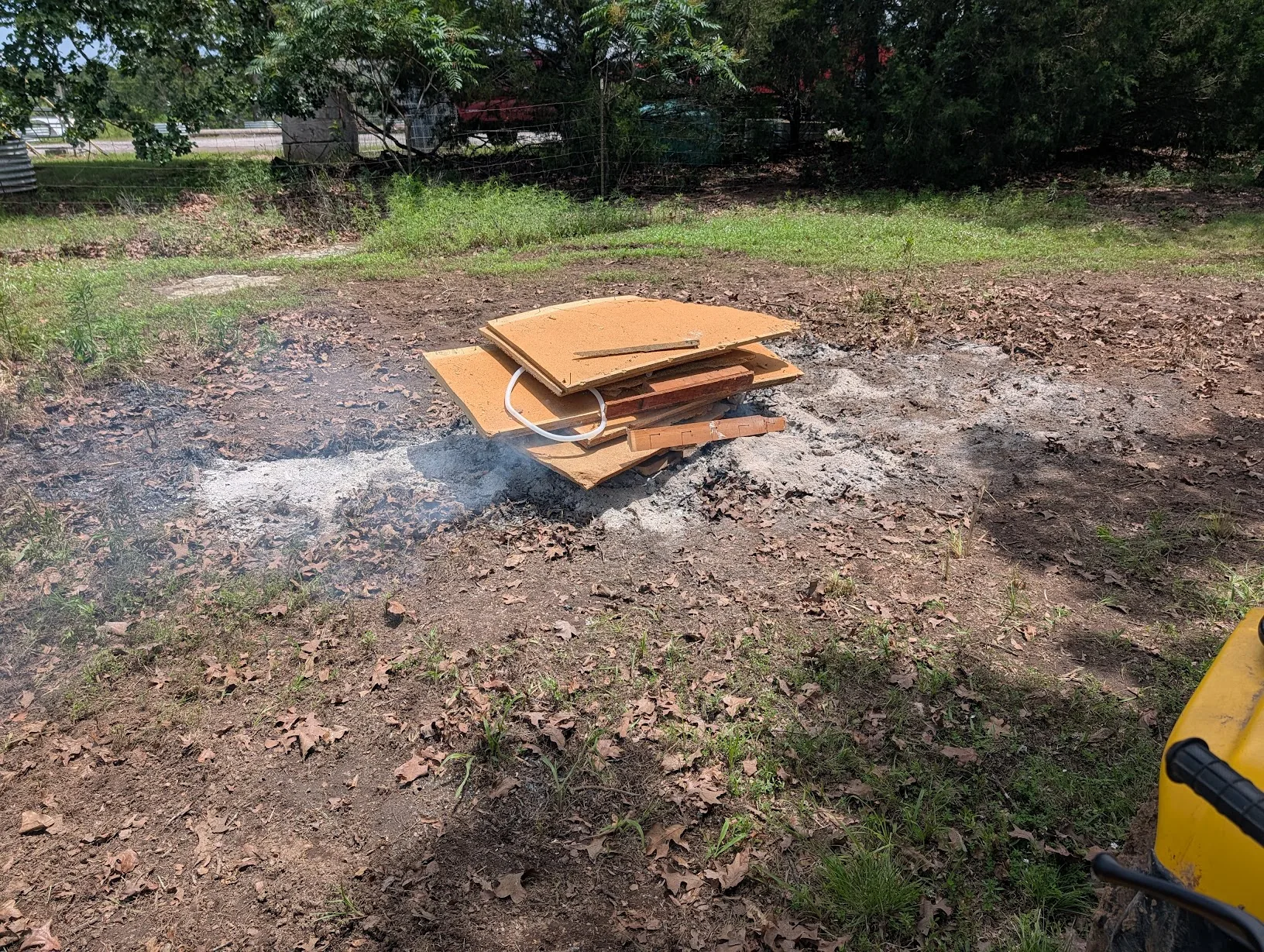 Workbench debris on top of a burn pile