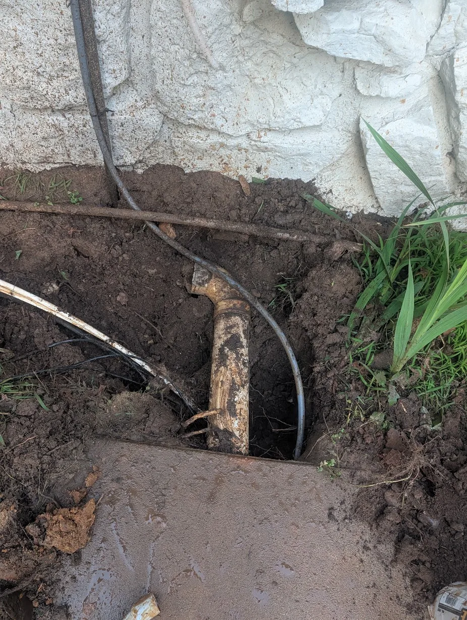 Unused buried PVC conduit with an open 90 found in the flowerbed