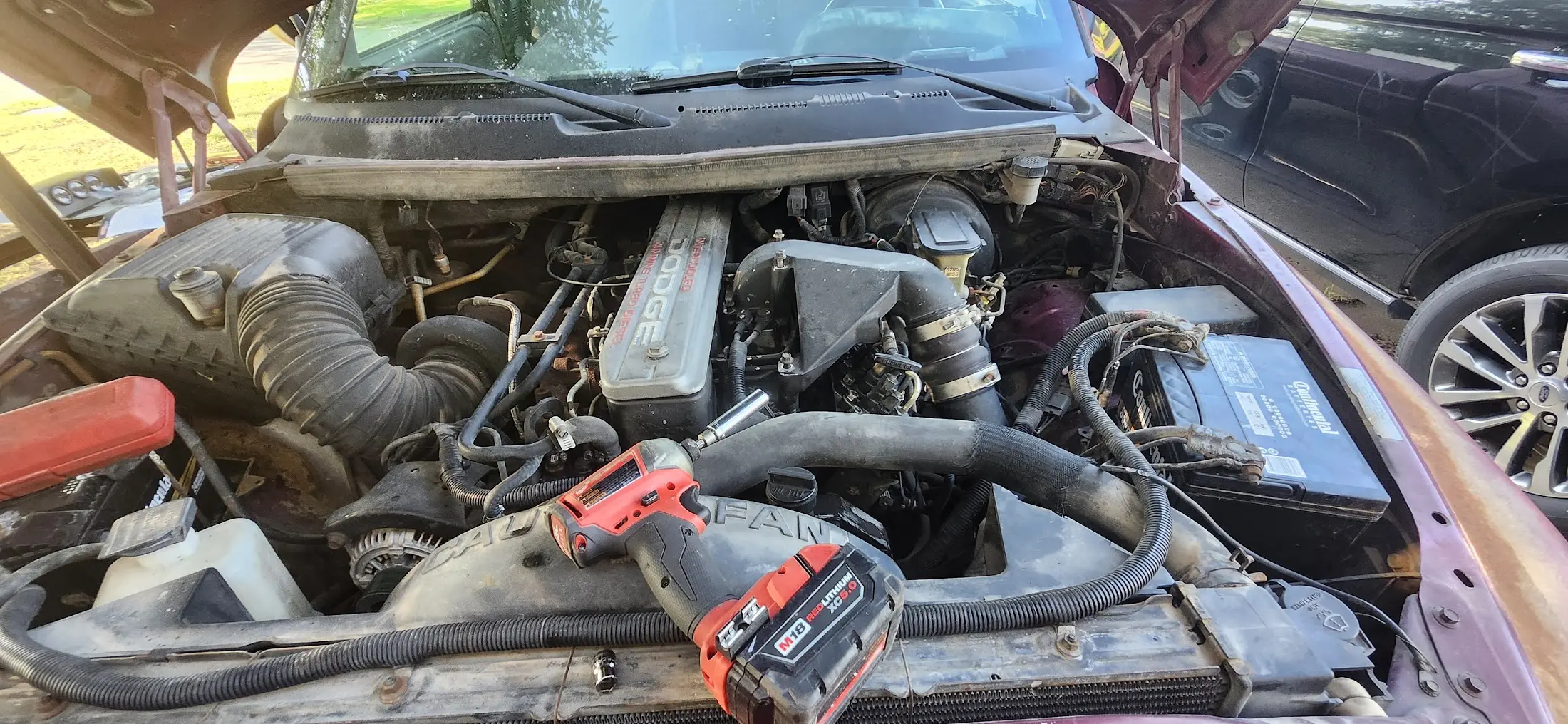 Image showing the intake horn removed along with my impact driver.