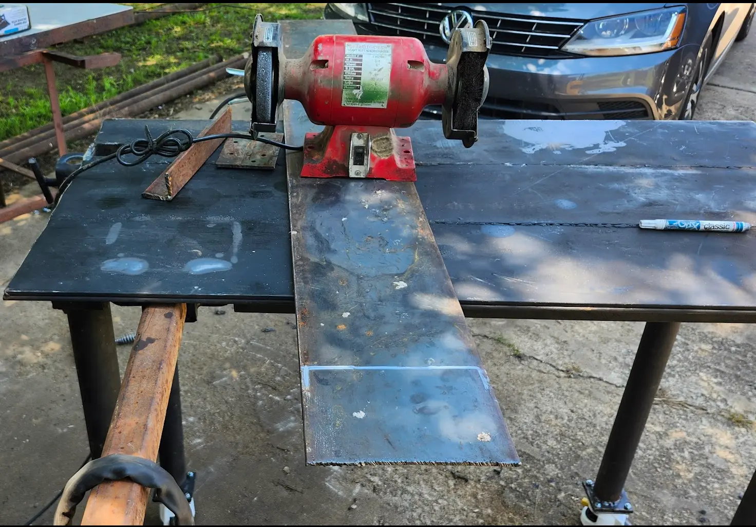 Photo showing the bench grinder sitting on top of the place used to make its base