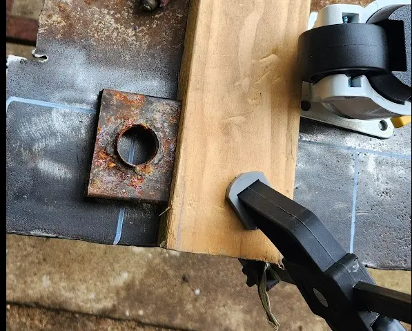 Photo of rusty homemade plasma guide used to cut the feet mounts.