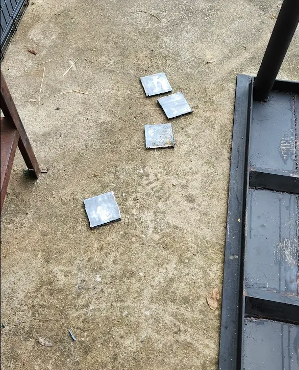 Photo showing the 4 pieces of steel plate sitting in the driveway