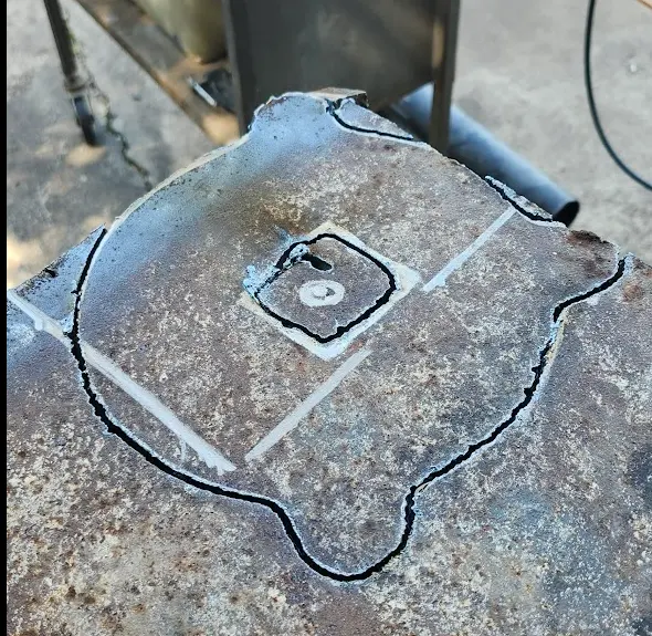 The plate metal, with the outline of the vise cut out