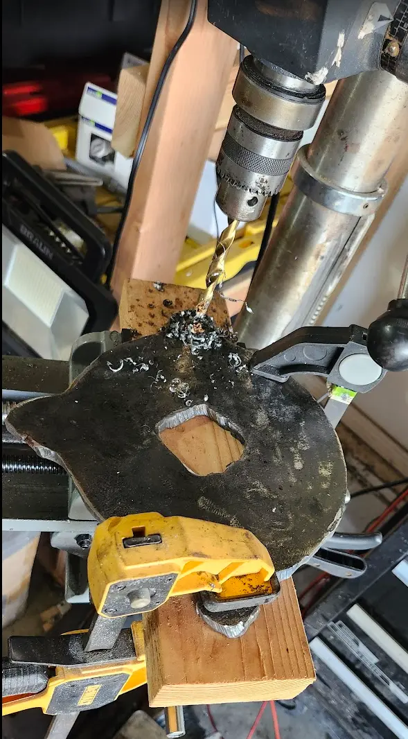 Photo showing the holes being drilled for the vise base plate